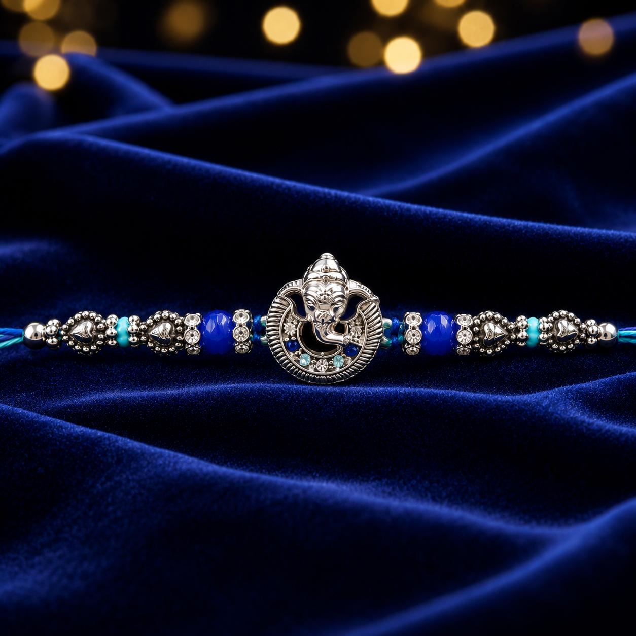 Lord Ganesha Designer Rakhi With Blue Beads For Men & Boys(1 Rakhi With Roli, Chawal, Chandan & Mishri Pack) - Image 2